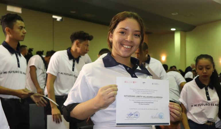 Joven mostrando su diploma de graduada